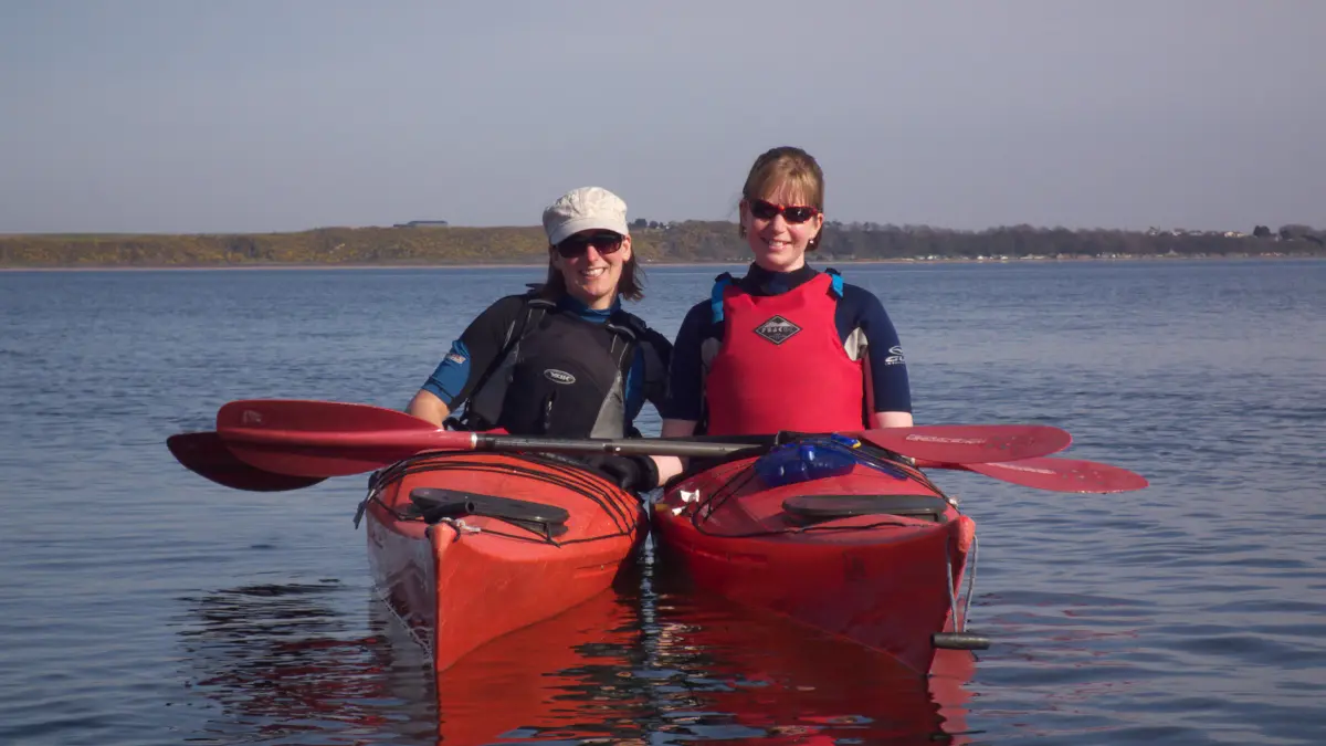 women sea kayaking in the sun