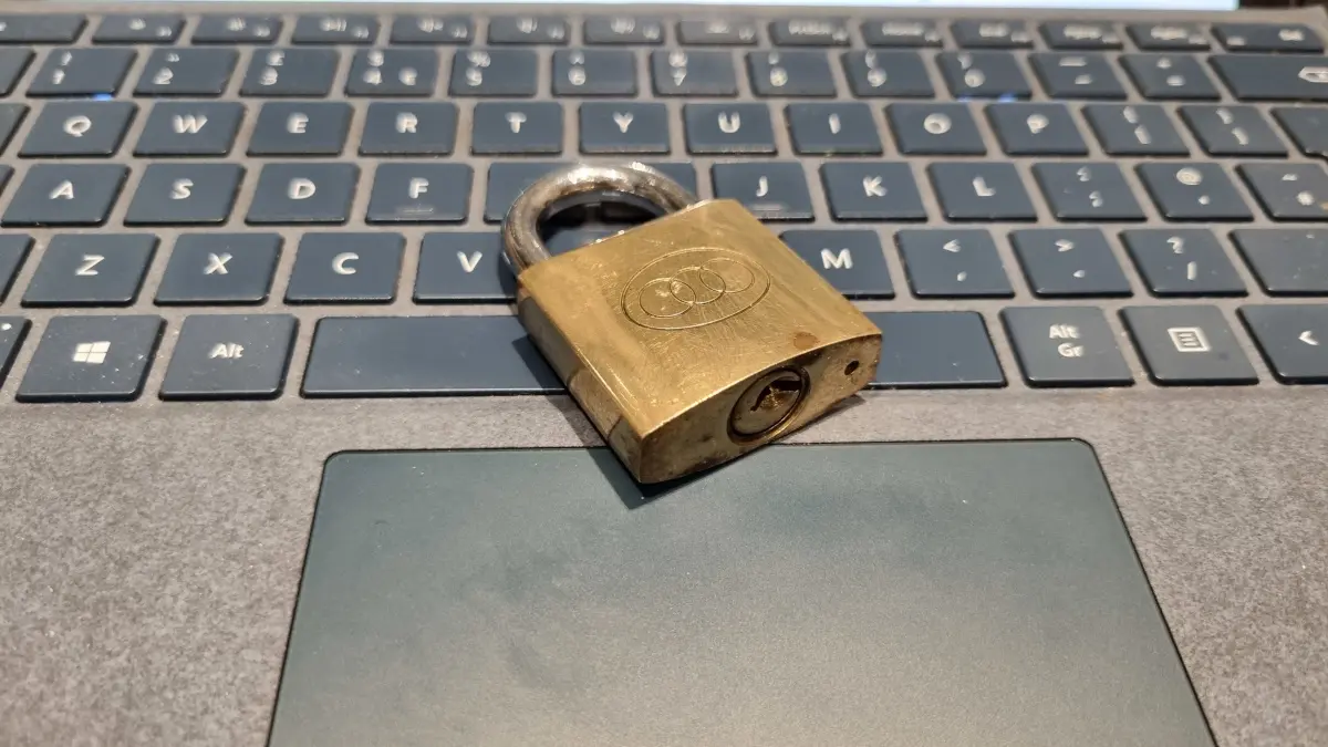 Brass padlock on computer keyboard